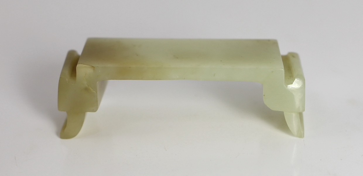 An early Chinese cream jade figure of Guanyin, together with a 19th century pale celadon and brown jade brushrest